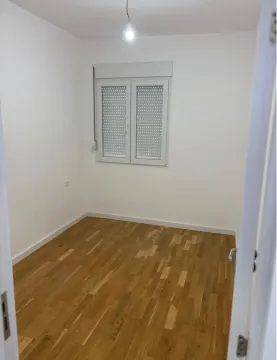Empty unfurnished room with white walls and wooden flooring. - image 4