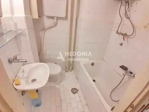Older bathroom with a bathtub, sink, and toilet. - image 7