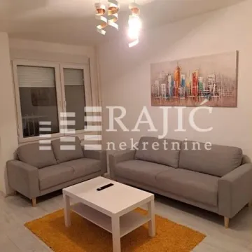 Living room with sofas, coffee table, and a wall painting. - image 3