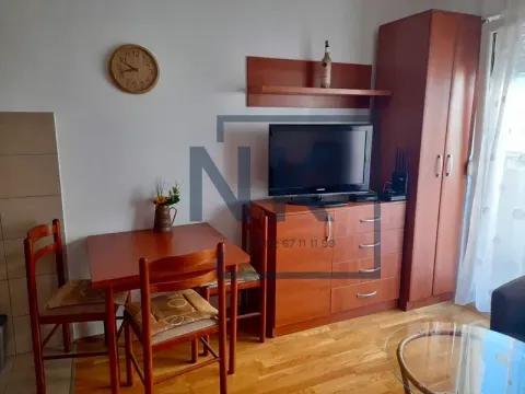 Living room with wooden furniture, TV, and dining table. - image 2