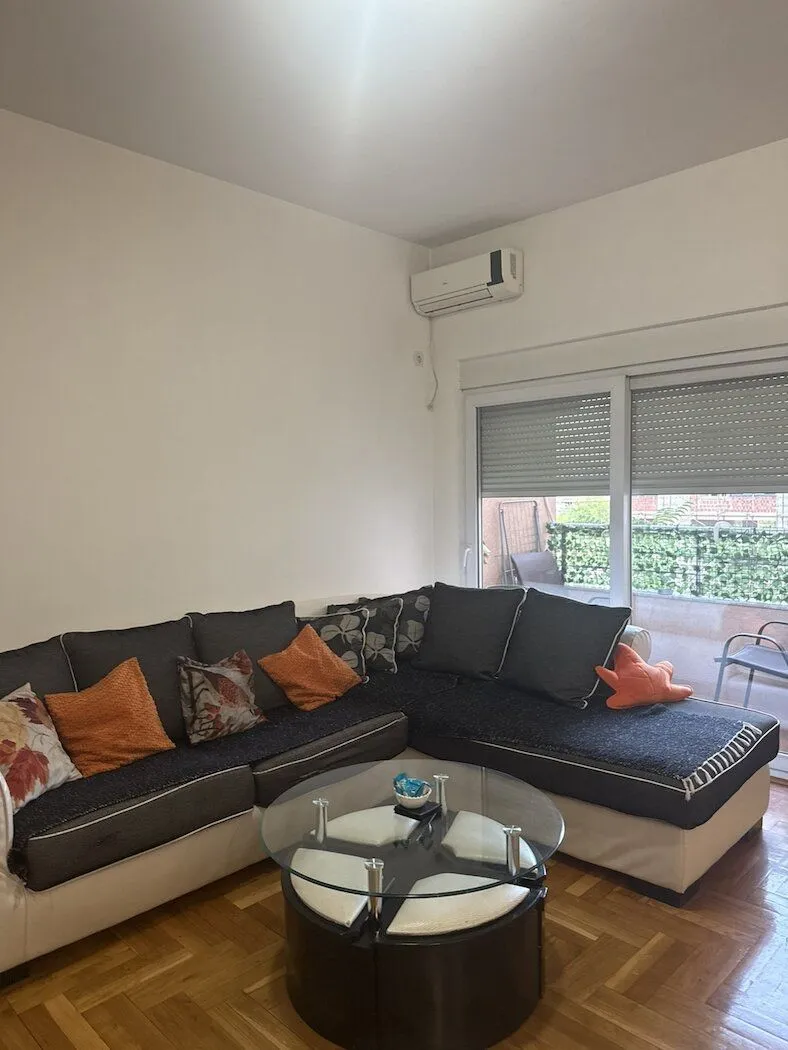 Living room with a corner sofa, coffee table, and access to the terrace.