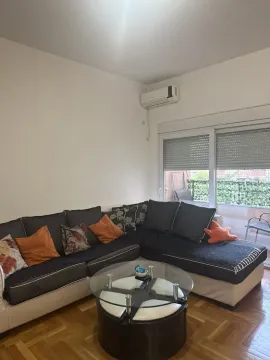 Living room with a corner sofa, coffee table, and access to the terrace. - image 3