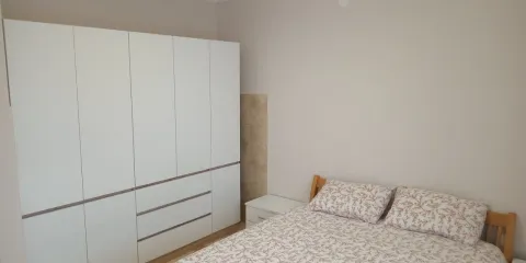 Bedroom with a double bed and a large white wardrobe. - image 6