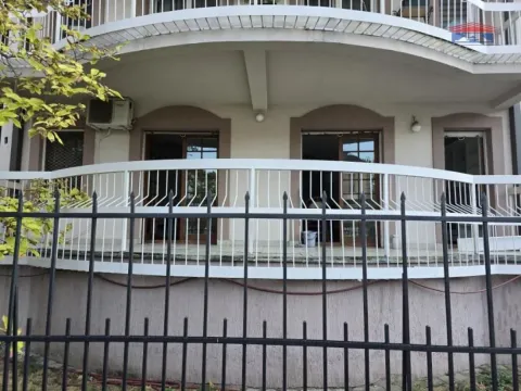 View of the exterior of the building with a terrace and fence. - image 2