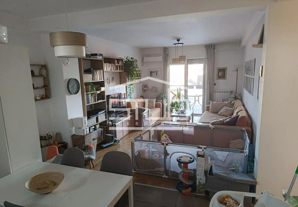 Living room with sofa set and dining table in the foreground.
