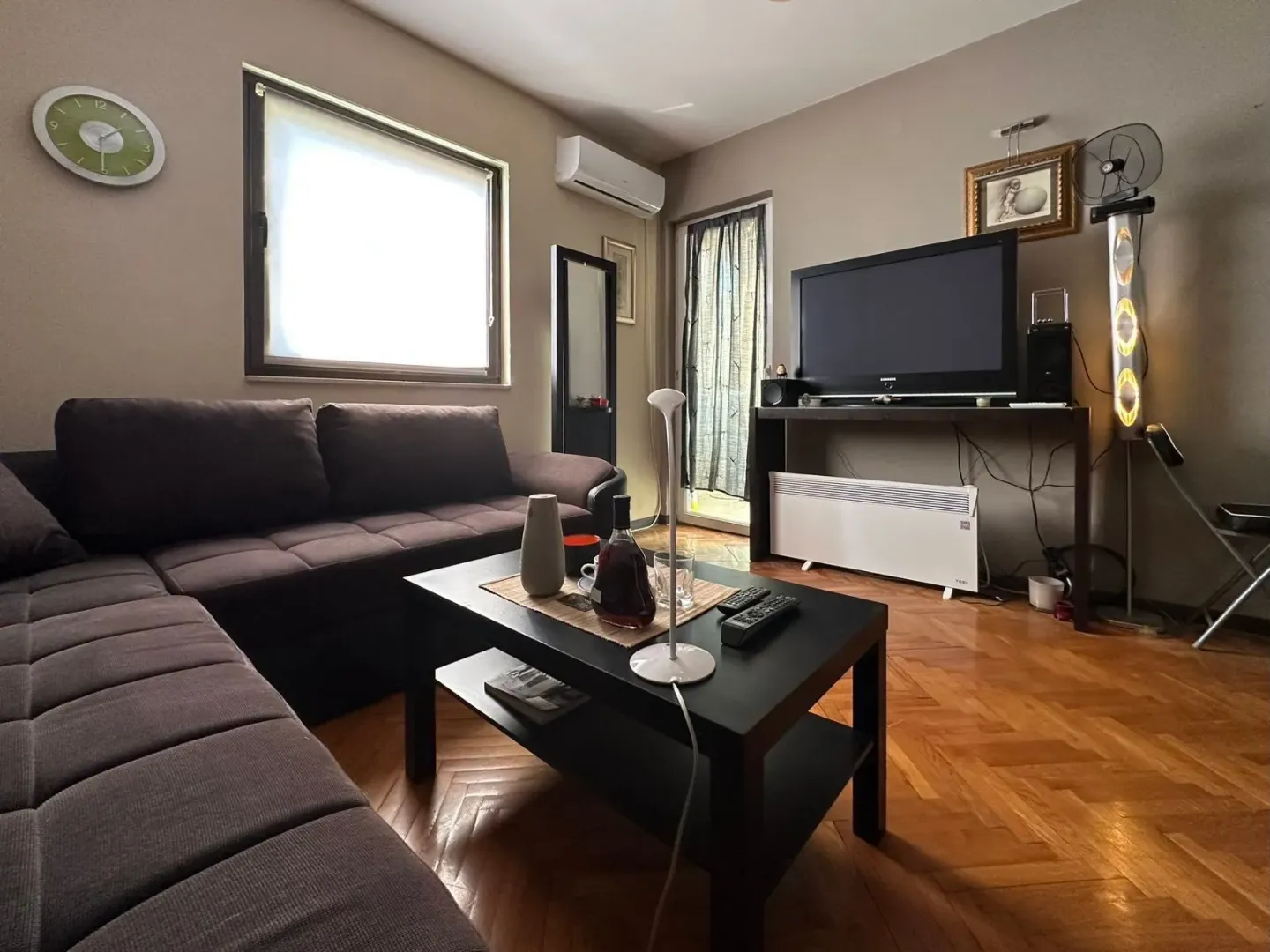Living room with sofa, coffee table, and television.