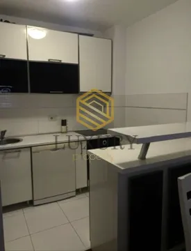 Modern kitchen with white cabinets and a breakfast bar. - image 5