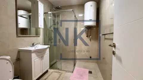 Bathroom equipped with a shower cabin, washbasin, and water heater. - image 5