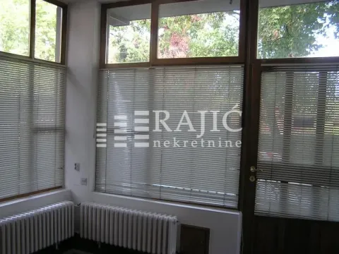 Bright room with large windows, blinds, and radiators underneath. - image 5