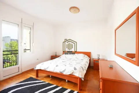 Furnished bedroom with a double bed, wooden furniture, and access to a terrace. - image 5