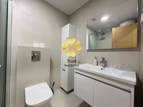 Modernly equipped bathroom with white sanitary ware and a mirror. - image 8