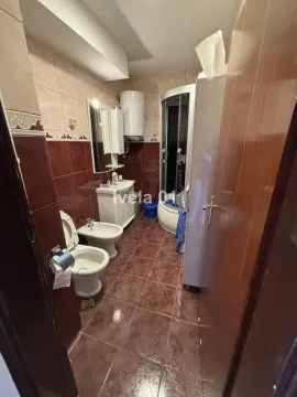 Bathroom equipped with sanitary ware, a shower cabin, and brown tones tiles. - image 3