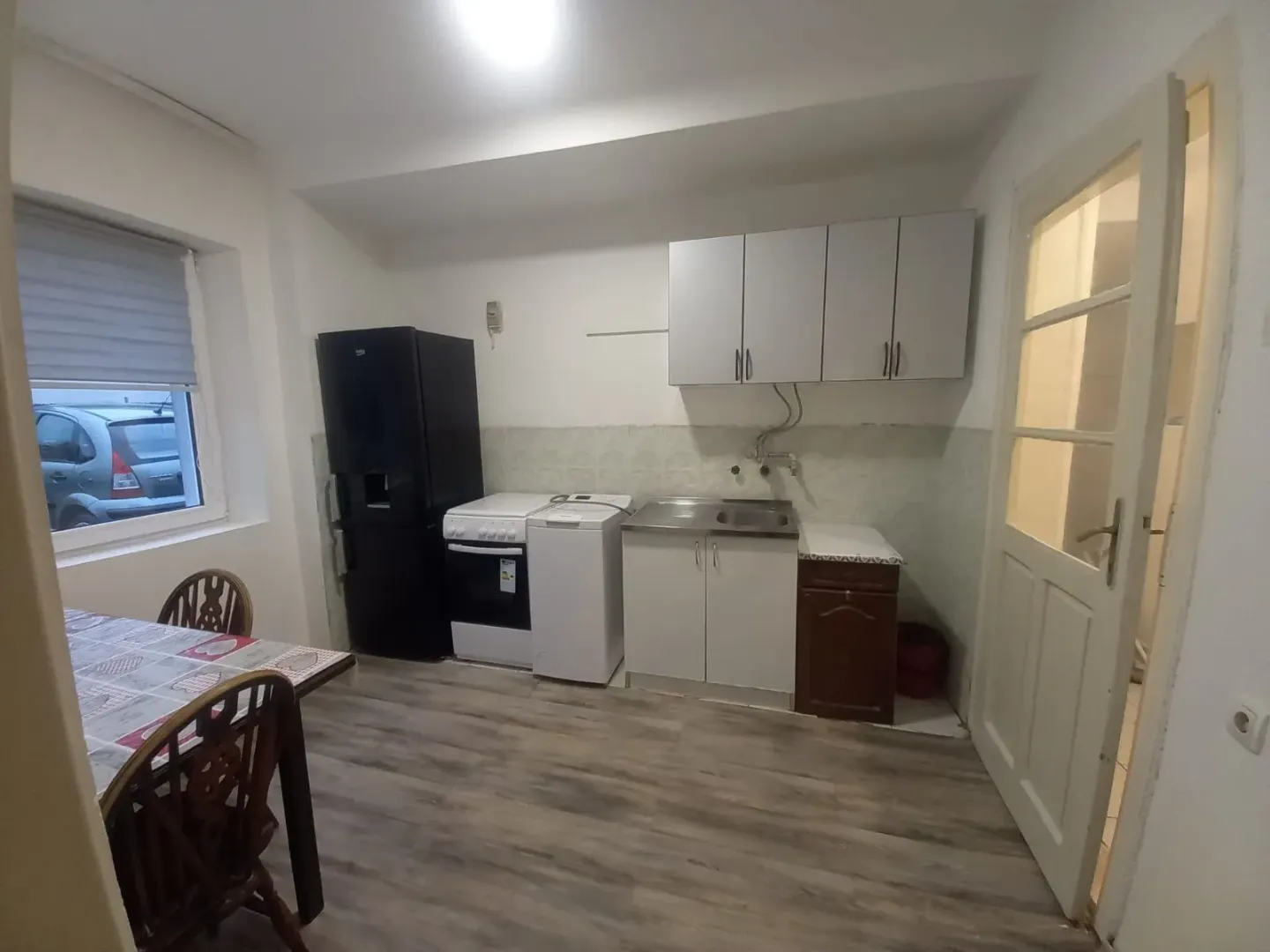 Small kitchen with a dining table and basic kitchen units.