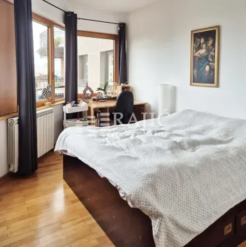 Bedroom with a double bed, a desk, and a window. - image 9