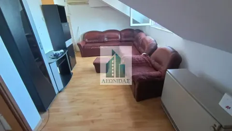 Living room with a leather sectional sofa and laminate flooring in an attic space. - image 12