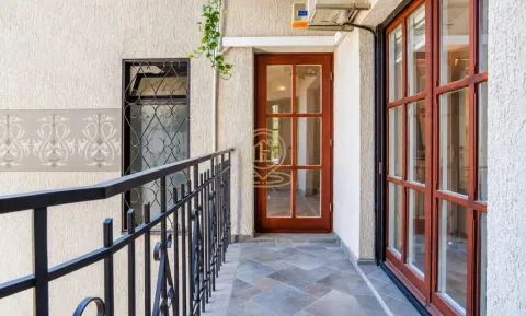 Balcony with metal railing and wooden doors and windows. - image 2