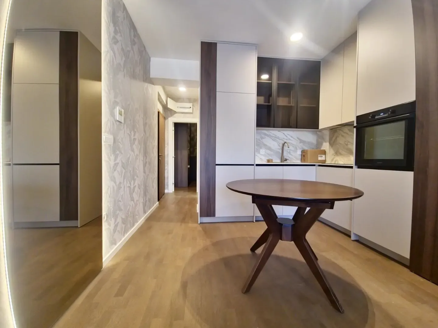 Modern kitchen with built-in cabinetry and a dining table.