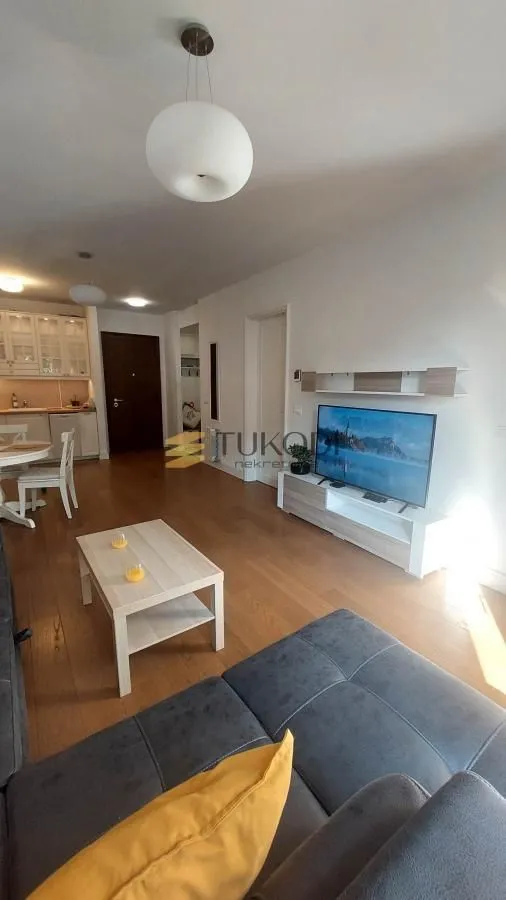 Living room connected with the dining area and kitchen in an open space layout.
