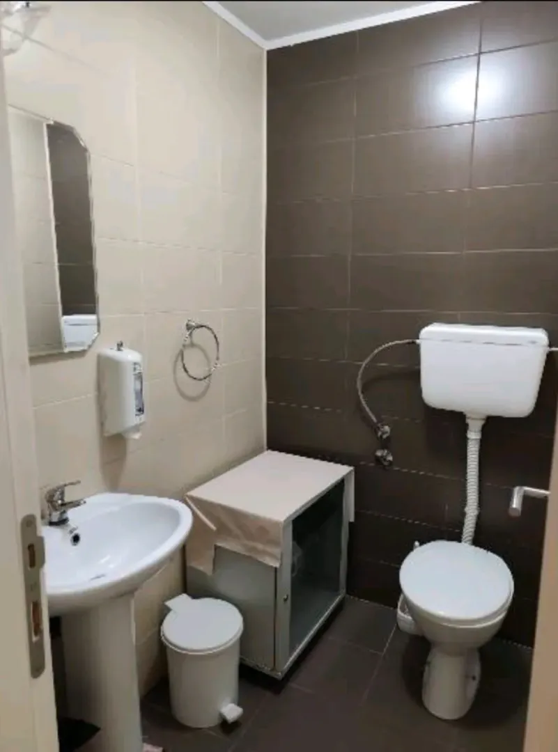 Smaller bathroom with a sink and toilet bowl.