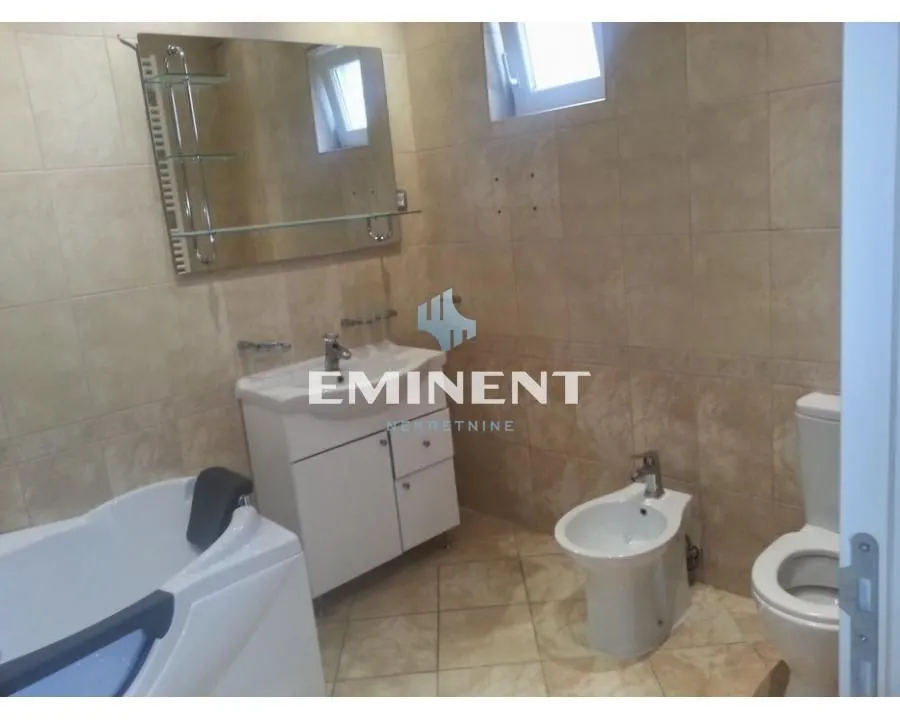 Bathroom equipped with a bathtub, vanity sink, bidet, and toilet.