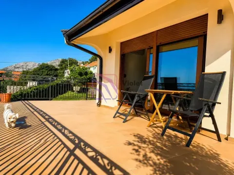 Spacious tiled terrace with outdoor seating and surrounding views. - image 10