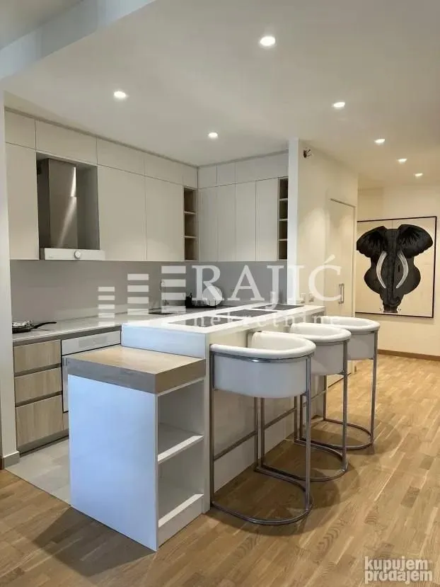 Modern kitchen with a breakfast bar and dining table.