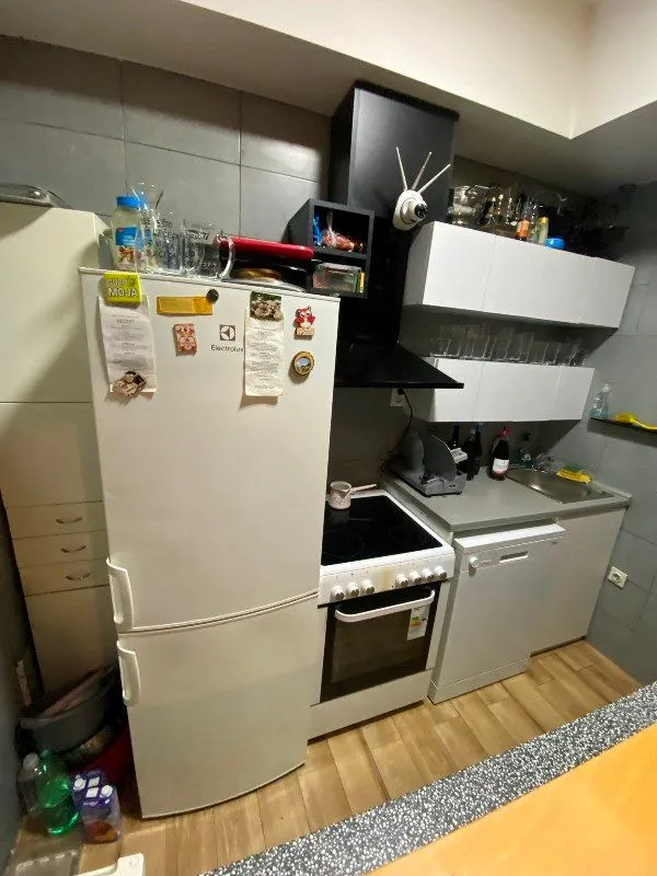 Small kitchen equipped with appliances and cabinetry.