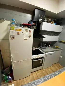 Small kitchen equipped with appliances and cabinetry. - image 10