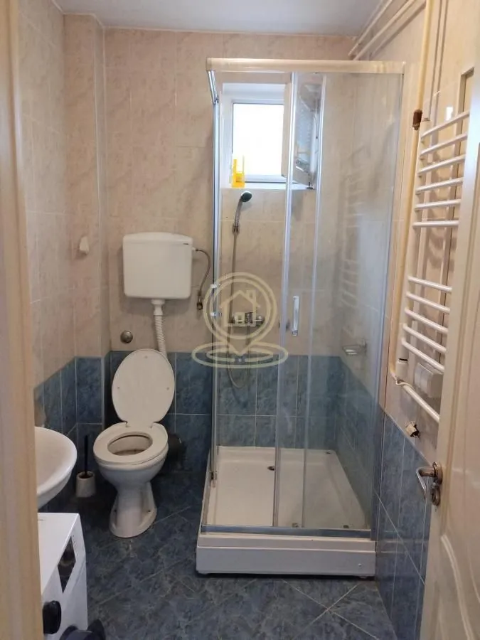 Manje kupatilo sa tuš kabinom, WC šoljom i umivaonikom.