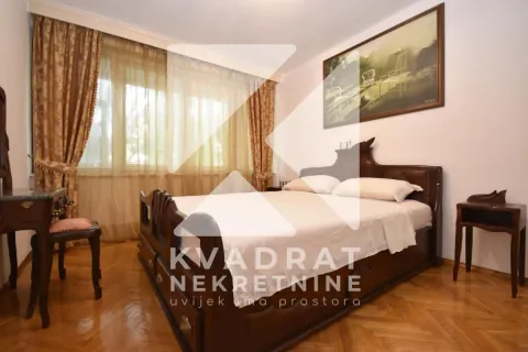 Bedroom with a double bed, wooden furniture, and a window with curtains. - image 9