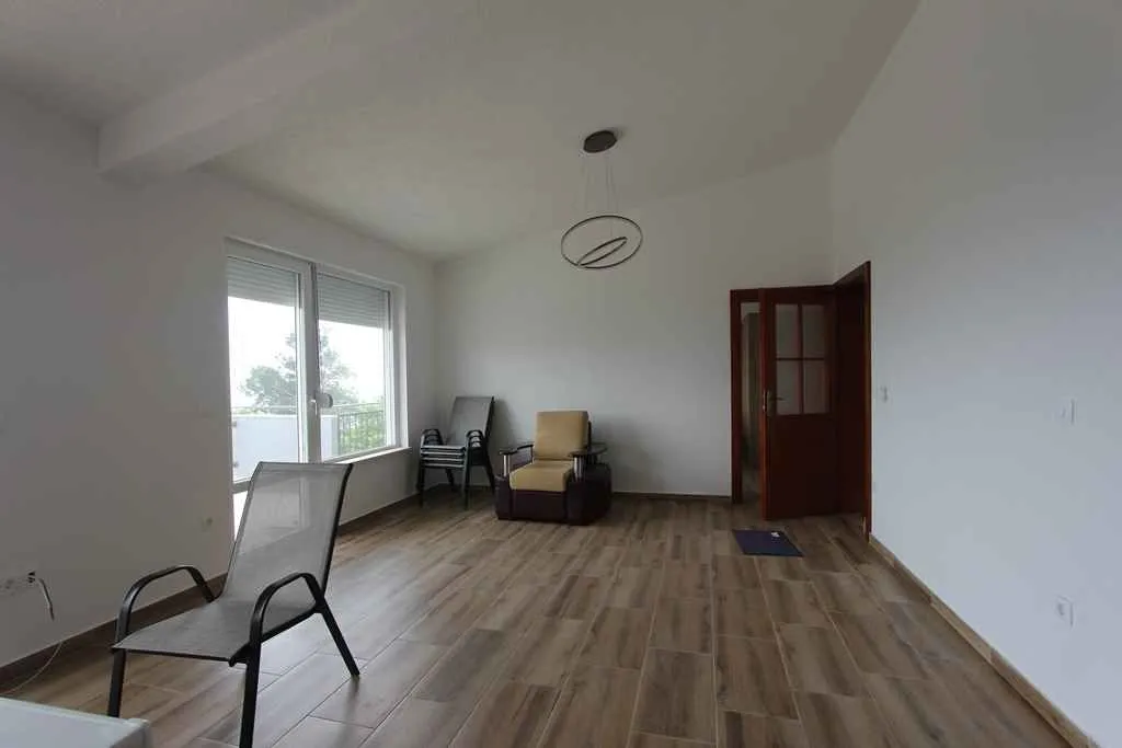 Spacious semi-furnished room with light floors.