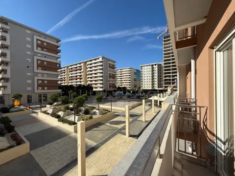 View from the balcony of the neighborhood and landscaped square with surrounding buildings. - image 7