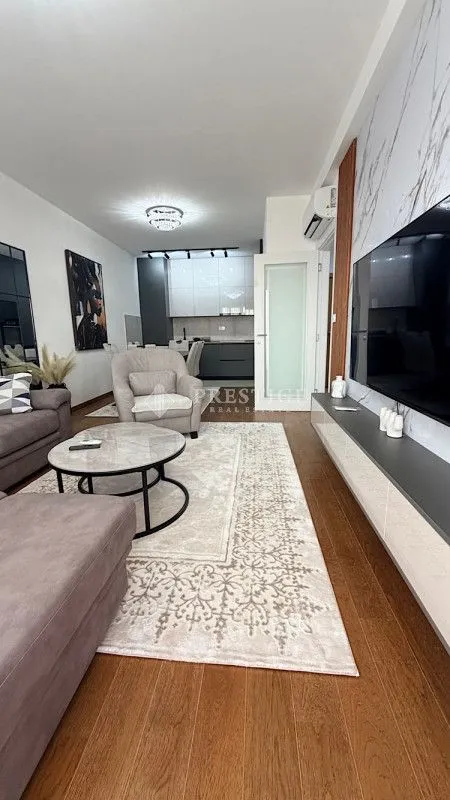 Modern living room with a sofa, coffee table, and TV.