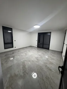 Empty room with glossy tiles and large windows. - image 5