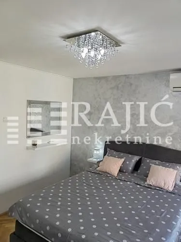 Furnished bedroom with a double bed.