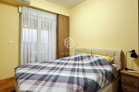 Furnished bedroom with a double bed, wardrobe, and balcony door. - image 20
