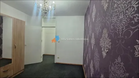 Furnished bedroom with a wardrobe and decorative wallpaper. - image 8