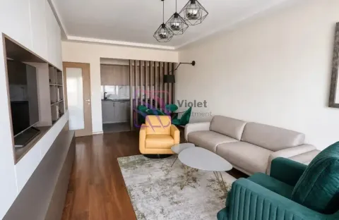 Living room with sofa set, TV unit, and a view of the dining area and kitchen. - image 3