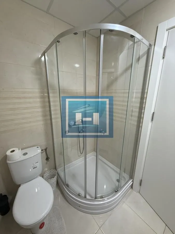 Bathroom with a shower cabin and toilet.