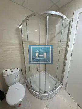 Bathroom with a shower cabin and toilet. - image 4