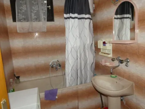 Bathroom equipped with a bathtub, washbasin, and mirror. - image 12