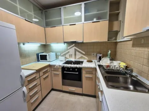 Kitchen with wooden cabinetry, built-in oven, and sink. - image 6