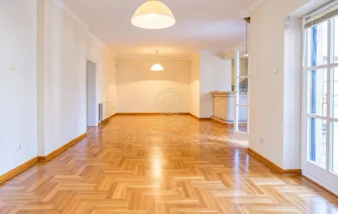 Spacious empty living room with parquet flooring and white walls. - image 8