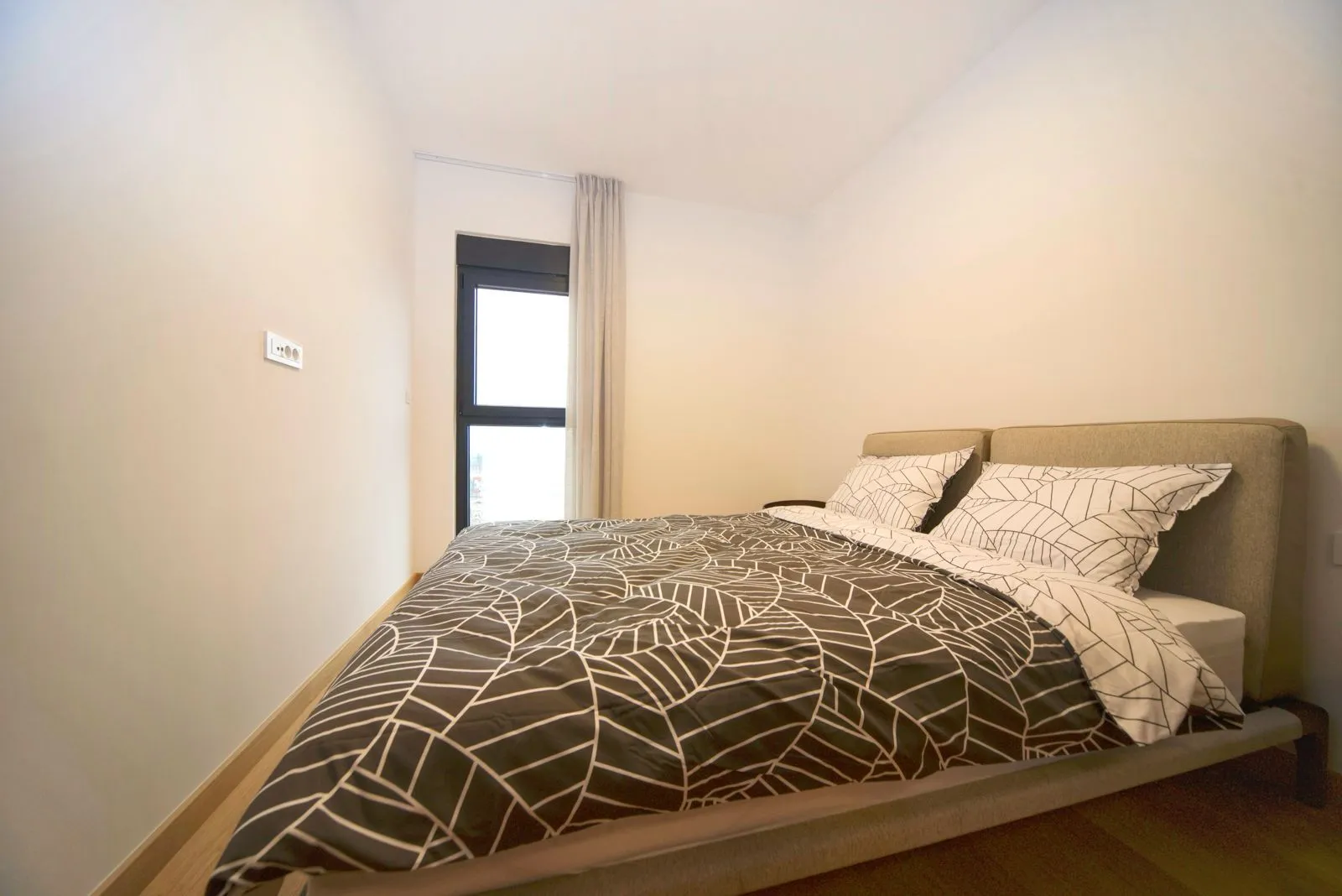 Bedroom with a double bed and a window.