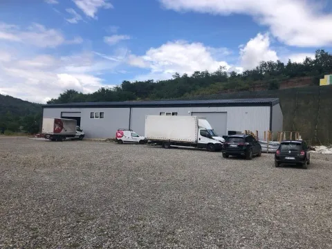 Exterior view of a commercial building with warehouse space and a parking lot in the yard. - image 3