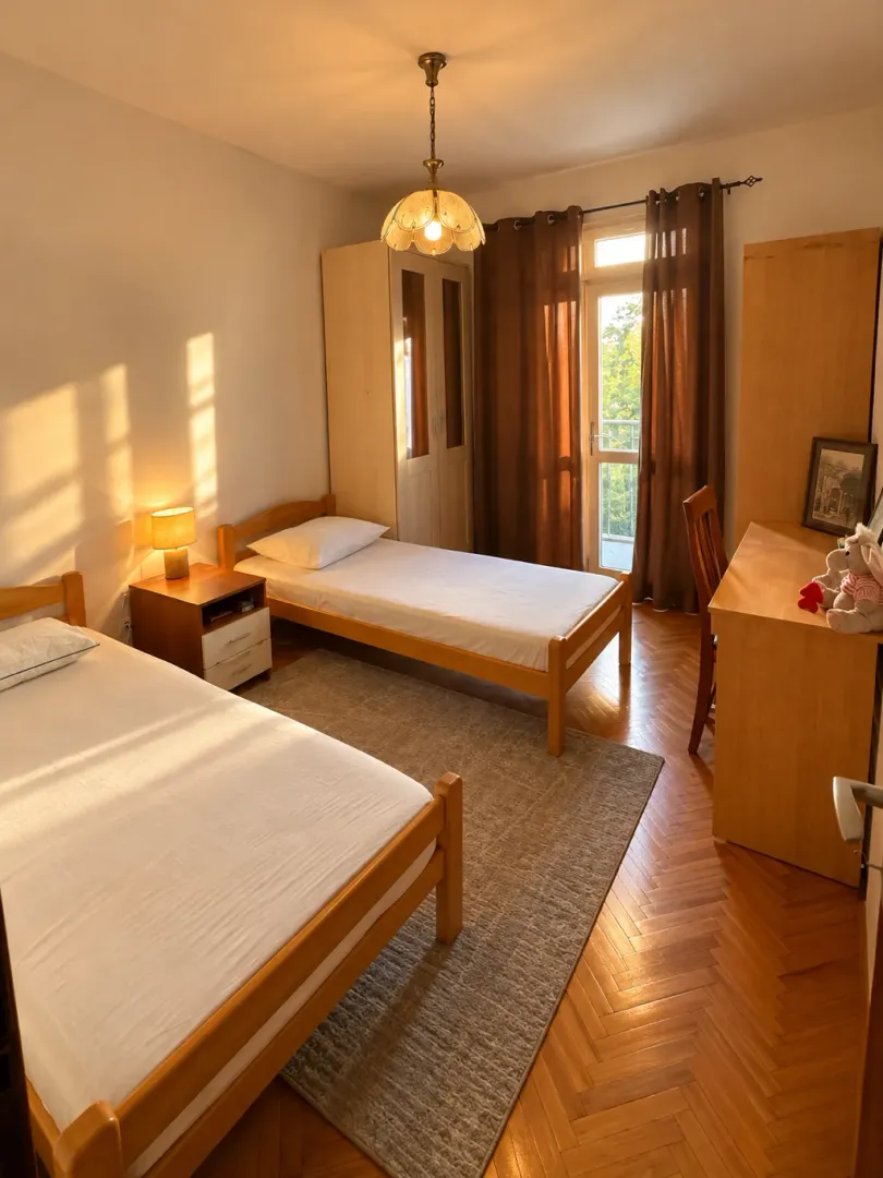 Furnished bedroom with two single beds and balcony access.