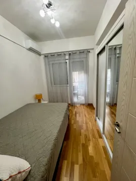 Smaller bedroom with a double bed, mirrored wardrobe, and air conditioning. - image 8