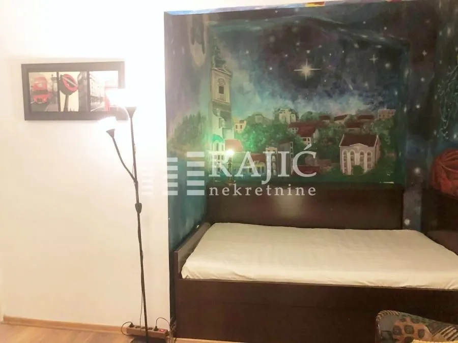 Bedroom with a bed and a painted wall mural.