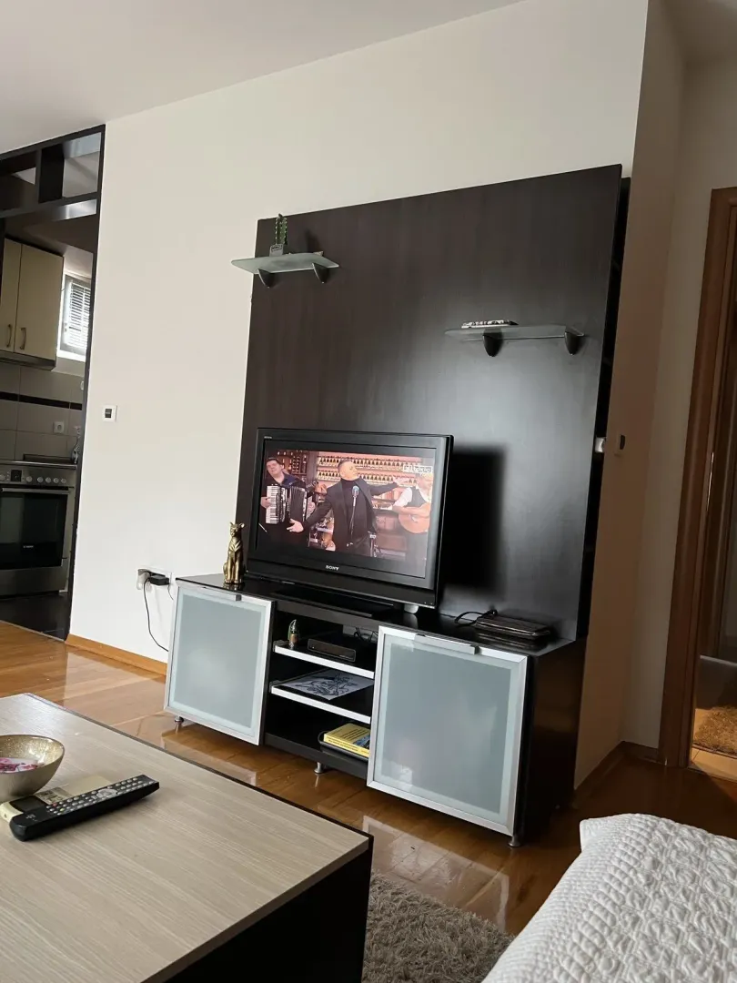Living room with a TV stand and a coffee table.