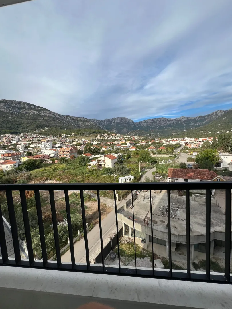 View from the terrace overlooking the settlement and mountains in the background.